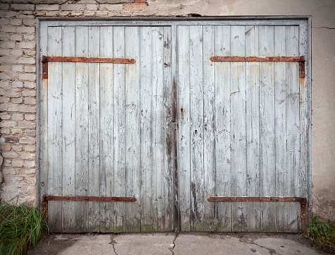 Old wooden neglected garage door.