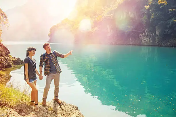 Photo of couple of travelers at the gorgeous lake