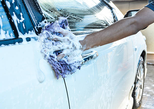 istock hand hold sponge over the car for washing 528875297