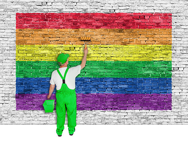 istock House painter covers brick wall with rainbow flag 528875831