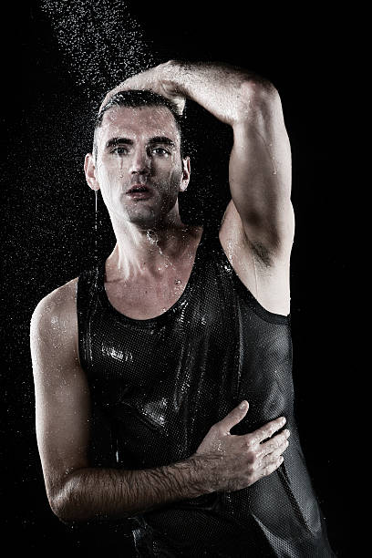 istock Young man with shirt taking shower 528875961