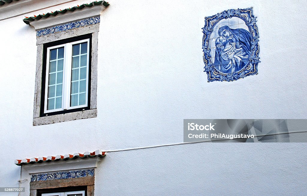 Azulejo image of Mary and Christ on building in Portugal Blue and white tiles form an image of Mary and Christ on the side of a building in Cascais, Portugal 19th Century Style Stock Photo