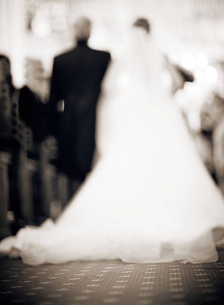 Bride and father in church defocused Bride in white dress and father walking down the aisle in catholic religious church defocused. bride hugging father on wedding day stock pictures, royalty-free photos & images