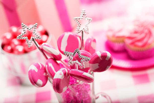 This is a close up photo of candy and cupcakes for a little girls party.