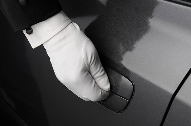 istock Doorman Opening Car Door 528885325