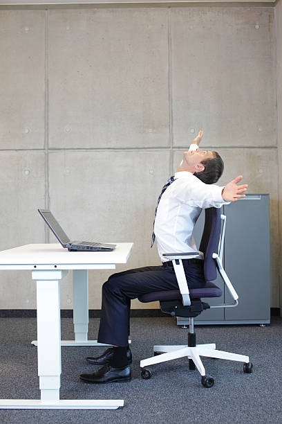 istock exercises in office. business man arms stretching 528887857