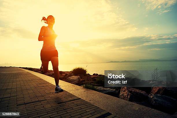Healthy Lifestyle Asian Woman Running At Sunrise Seaside Stock Photo - Download Image Now