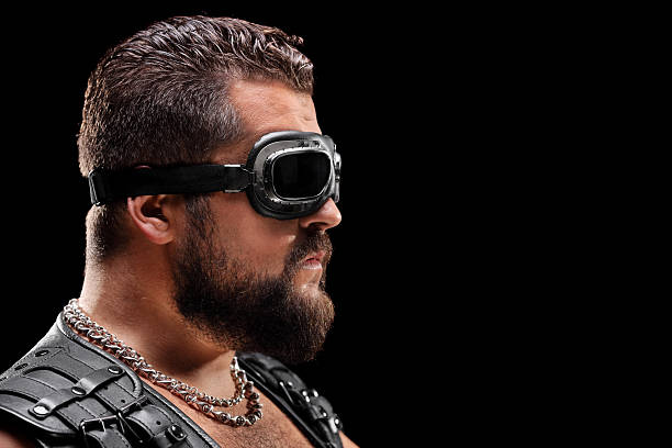 istock Male biker with goggles on black background 528888899