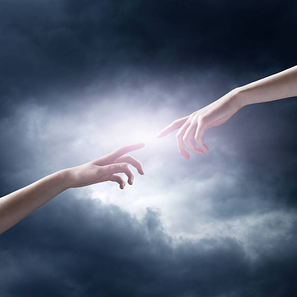 istock religion concept. finger touching the magic sky 528889937