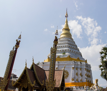 golden and white asian art pagoda in Thai monastery