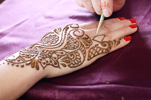 henna being applied stock photo