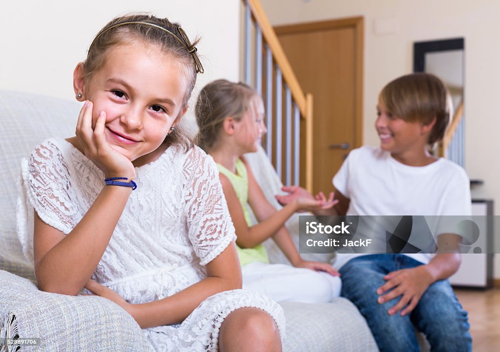 First amorousness:  girl and couple of kids apart First amorousness:  spanish girl and couple of kids apart indoors Apartment Stock Photo