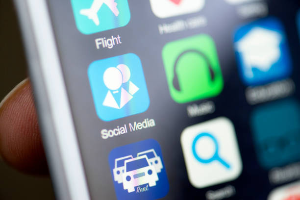 Hand holding phone, social media app icon on screen