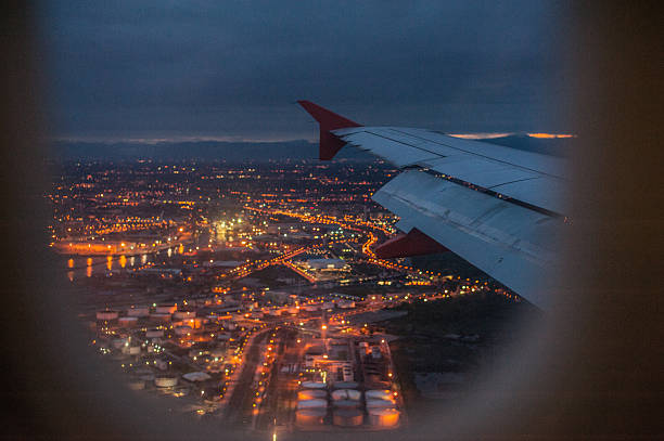istock City at night through airplane window 528896826