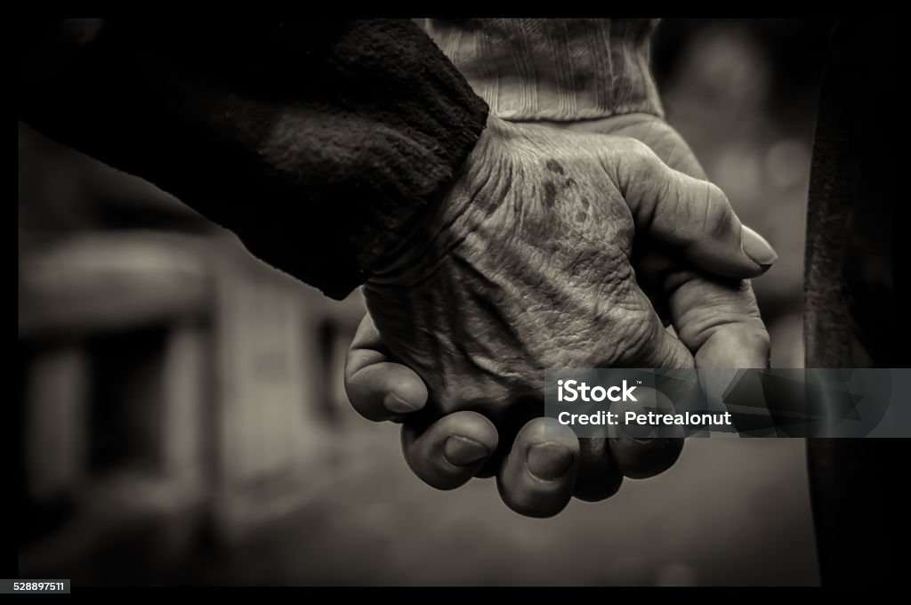 Old couple holding hands Detail of an old couple holding their hands Black And White Stock Photo