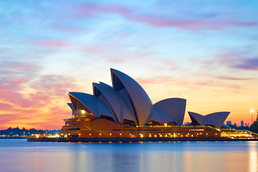 Sydney Australia - April 2, 2016: Early morning in Sydney, and the iconic shape of the city's Opera House stands out against a glorious pre-dawn sky .