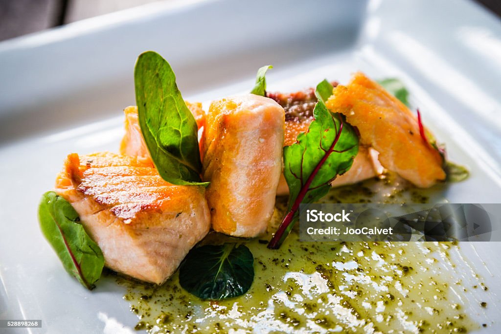 Plate of salmon and arugula Close up of Plate of salmon and arugula. Fresh and bright look Gourmet Stock Photo