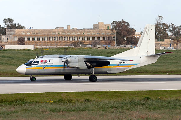 Cargo Antonov An-26 backtracking after landing runway 14. Luqa, Malta - March 16, 2005: Cityline Hungary Antonov An-26 antonov an 26 stock pictures, royalty-free photos & images
