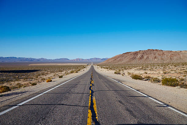 istock Road through the desert leading to Death Valley, Nevada 528899249