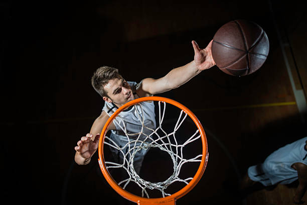 Professional basketball player penetrating to the basket and scoring a basket with a lay up.   