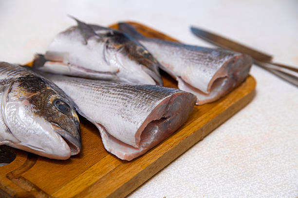 istock Dorado fish on a cutting board knife cut half 528899581
