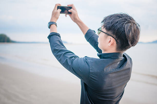istock Business man working with  smartphone beach background 528901156