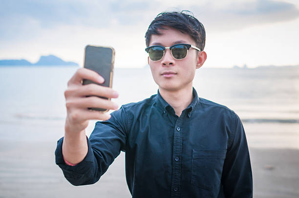 istock Business man working with  smartphone beach background 528901314