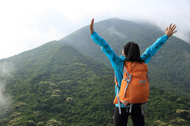 istock cheering woman hiker enjoy the view on mountain peak 528901318