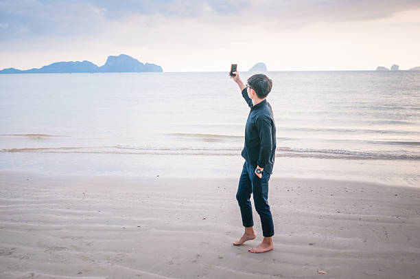 istock Business man working with  smartphone beach background 528901506