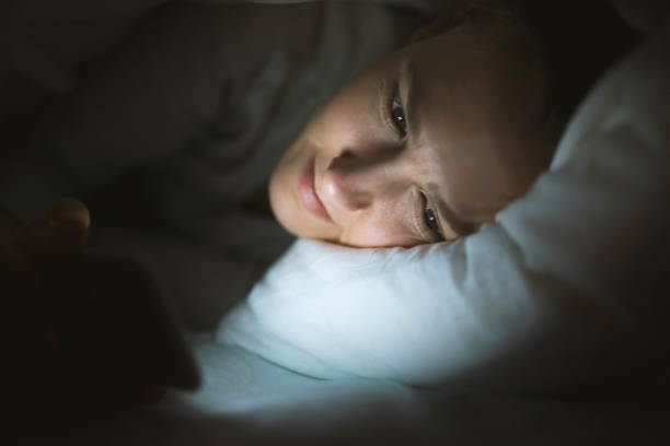 istock Woman using phone in bed at night 528902966