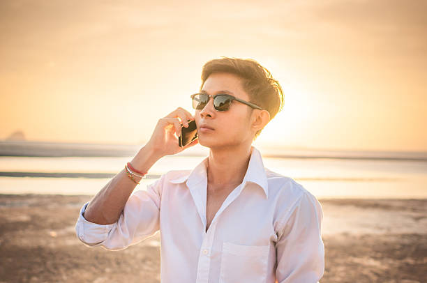 istock Business man working with  smartphone beach background 528905050