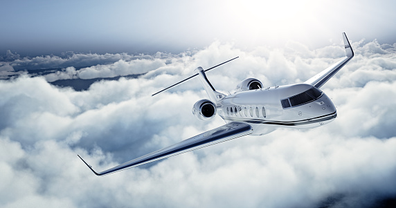 Realistic photo of White Luxury generic design private jet flying over the earth. Empty blue sky with white clouds at background. Business Travel Concept. Horizontal. 