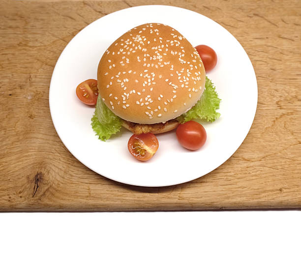 hamburger de bœuf servi avec de la salade et des tomates dans une assiette - white food and drink industry hamburger cheeseburger photos et images de collection