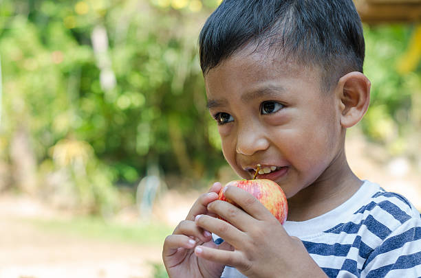istock Asian Child Try Eat The Apple. 528906352