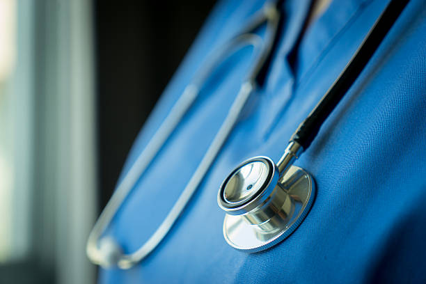 istock Stethoscope on nurse & doctor coat background 528906976