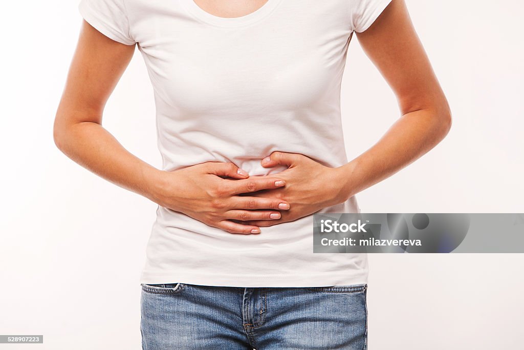 woman is having stomach ache Woman heaving belly ache, on white background Stomachache Stock Photo