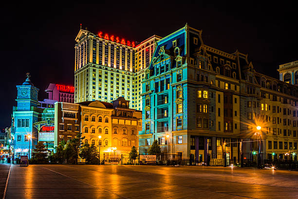 Buildings on the boardwalk at night in Atlantic City Buildings on the boardwalk at night in Atlantic City, New Jersey. boardwalk stock pictures, royalty-free photos & images