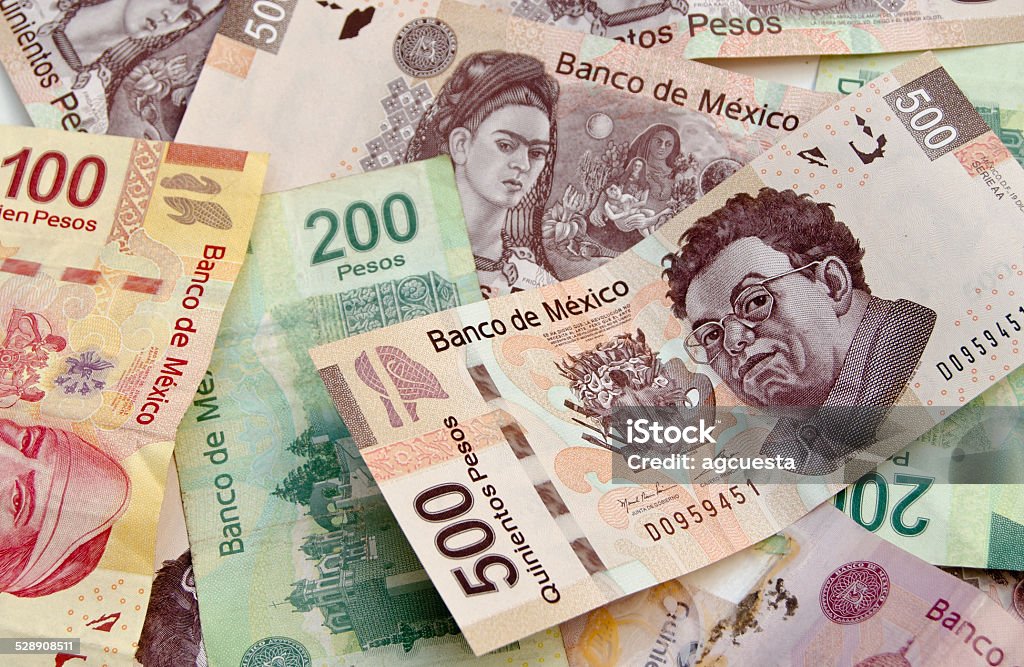 Mexican Peso bank notes background Mexican Pesos, bank notes, colorful background with diferent denominations including 500 pesos currency bills with Diego Rivera and Frida Kahlo faces. Mexican Pesos Stock Photo
