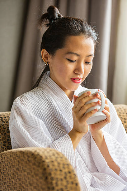 istock Robe Wearing Young Asian Woman With Coffee or Tea 528909306