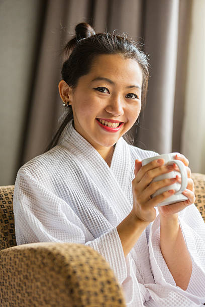 istock Robe Wearing Young Asian Woman With Coffee or Tea 528909456