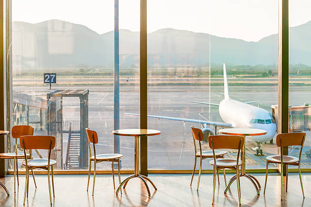 Airport seating area for business travellers with tablets and pay stations