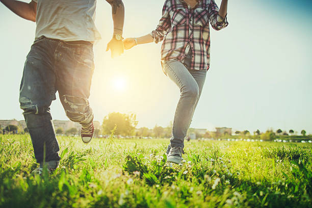 istock Couple running on a green field together 528911980
