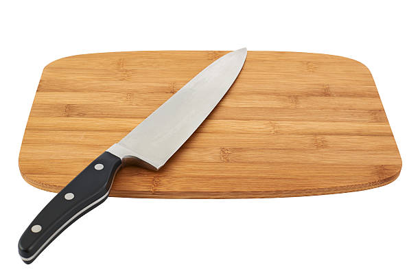 istock Knife over wooden cutting board 528912832