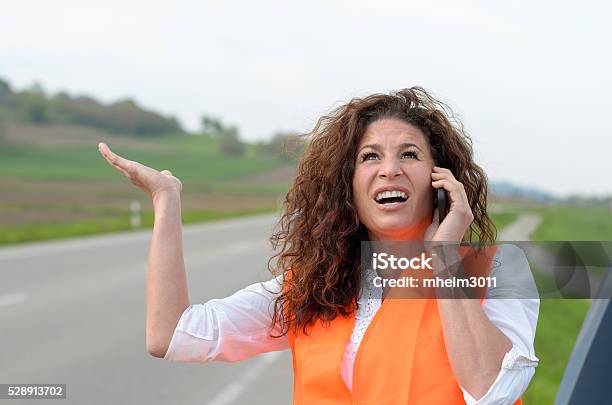 Exasperated Young Female Driver On Her Mobile Stock Photo - Download Image Now - Adult, Assistance, Beautiful People