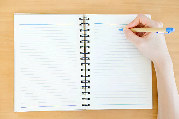 istock Hands open book mock up on wood table 528916656