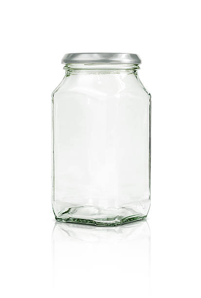 istock Clear glass bottle with silver cap isolated on white 528918752