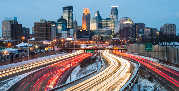 Heavy traffic flowing in and out of Minneapolis just after sunset, on a cold winter evening.