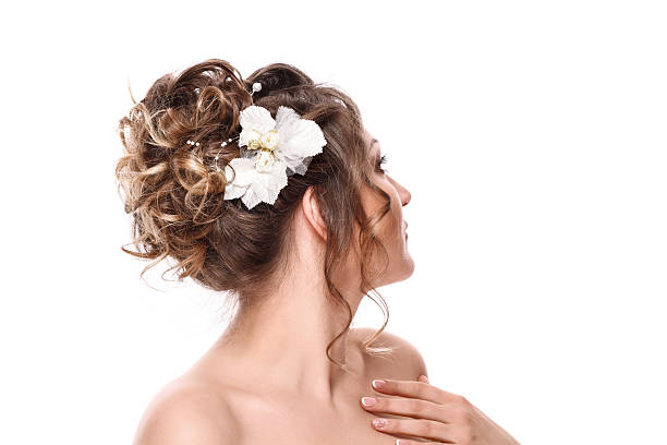 young woman bride with beautiful hairstyle and stylish hair accessory, rear view. Isolated on white background.