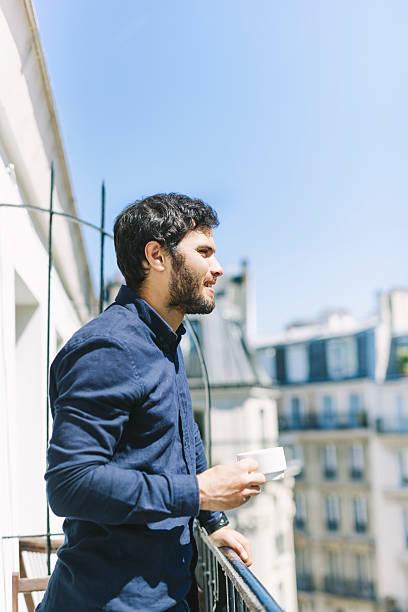 istock Young Businessman Starting His Morning on a Sunny Balcony 528922046