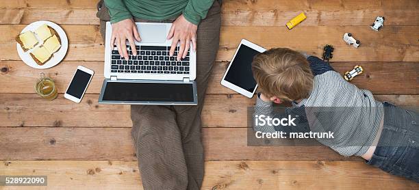 Mother And Son Using Tablet And Laptop Stock Photo - Download Image Now - Family, Child, Laptop